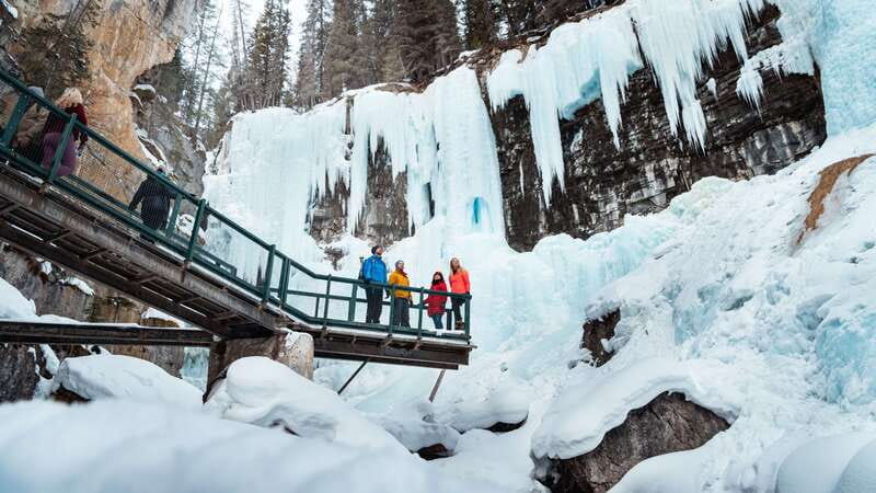 Banff: Morning or Afternoon Johnston Canyon Icewalk - Getting ready at the trailhead: ice cleats, poles, and a fast safety reset